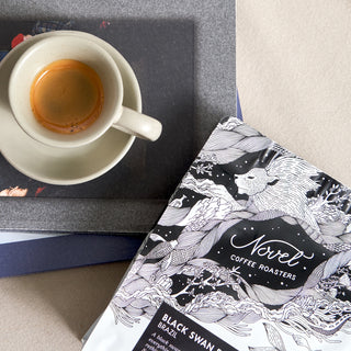 overhead photograph of a bag of black swan coffee next to a shot of espresso