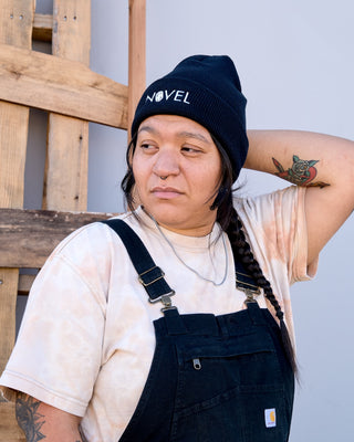 Woman wearing black cuffed Novel beanie